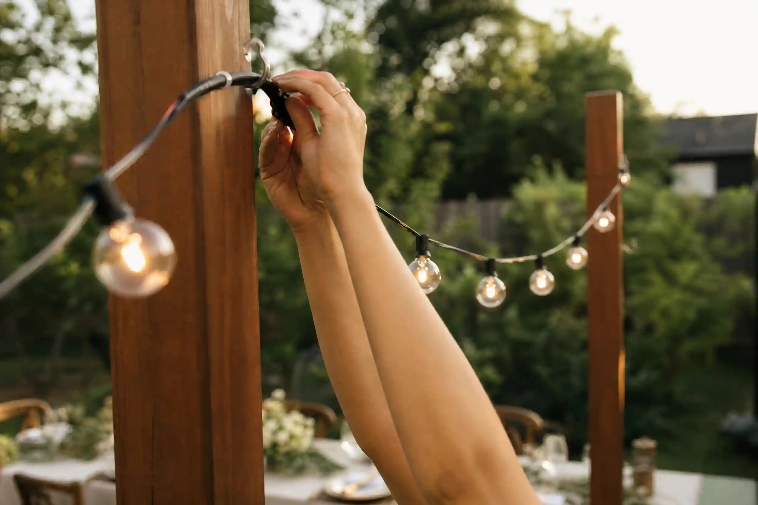 small backyard wedding ideas with string lights and long table,cozy small backyard wedding ideas with mismatched chairs and florals,budget-friendly small backyard wedding ideas table setup
